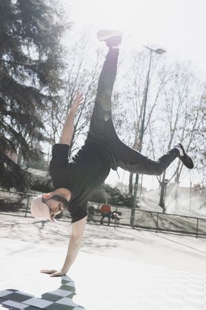 Man dancing break dance in park