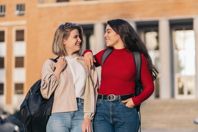 Two students portrait in college looking each other. Blonde and brunette