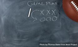 American football with game plan on chalkboard 0Wg1p0