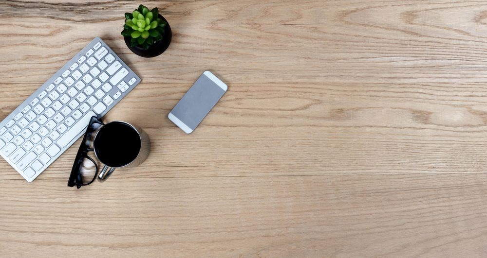 Wooden desktop with computer keyboard and coffee for a work or school setting