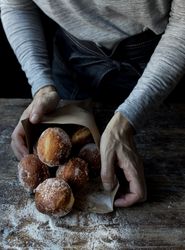 Person near baked cakes on table