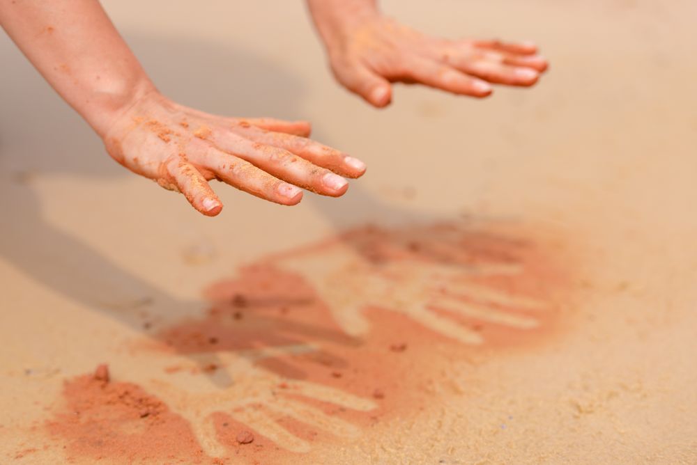 Person spraying their hand print