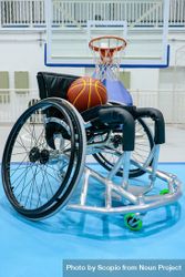 Basketball on wheelchair in an a basketball field 4mKWW0