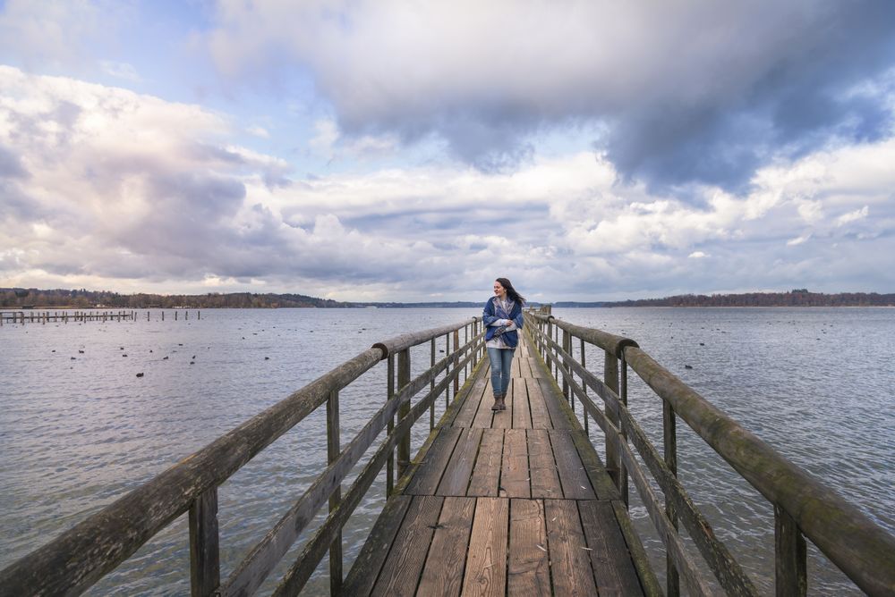 Smiling woman walking on a bridge