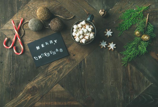 Homely holiday with “Merry Christmas” card, hot chocolate, copy space