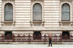 Male tourist walking near old building