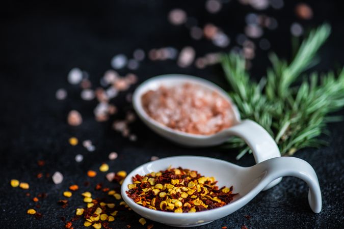Close up of chilli flakes, rosemary and salt