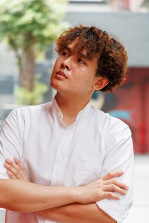Portrait of Asian man standing with arms crossed