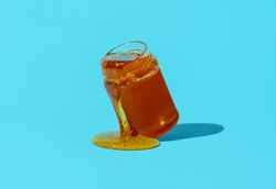 Honey jar isolated on a blue background