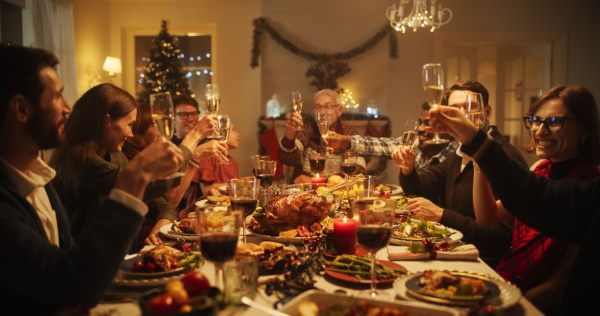 Old and Young Family Members Raising and Clinking Glasses to Celebrate a Festive Occasion
