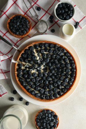 Concept of tasty lunch with blueberry pie on light background