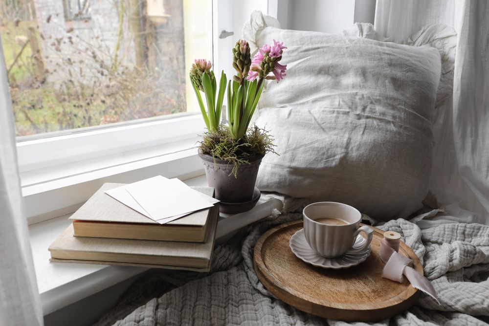 Pot of flower with cards and cosy cup of morning coffee