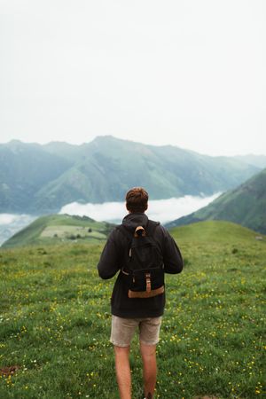 Anonymous male admiring view of mountain ridge