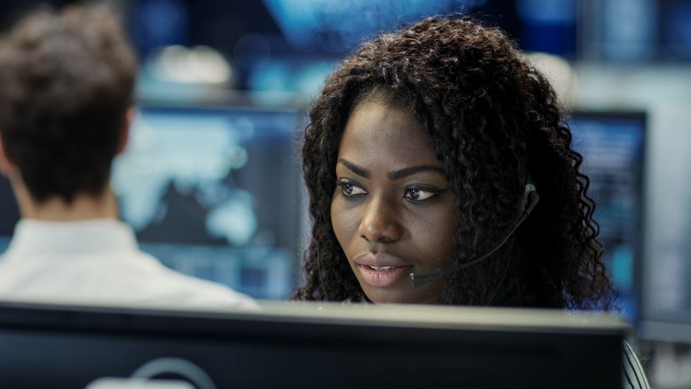 Female Customer Service Representative Answer Client's Questions in a Headset.