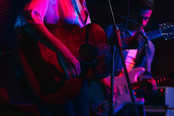 Musicians In Stage With Colorful Lights Performing In A Live Concert