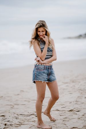 Happy female posing on sandy beach