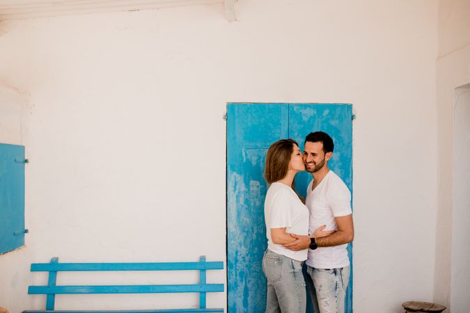 Loving couple cuddling near beach house