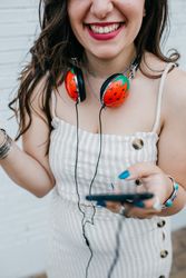Woman with bright headphones and mobile phone