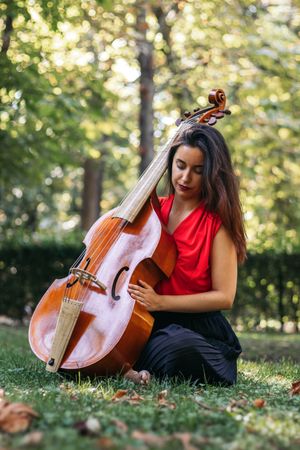 Woman with cello in a park