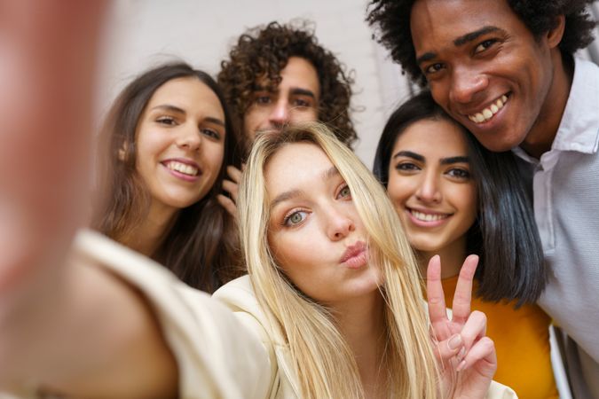 Smiling friends taking a selfie outside