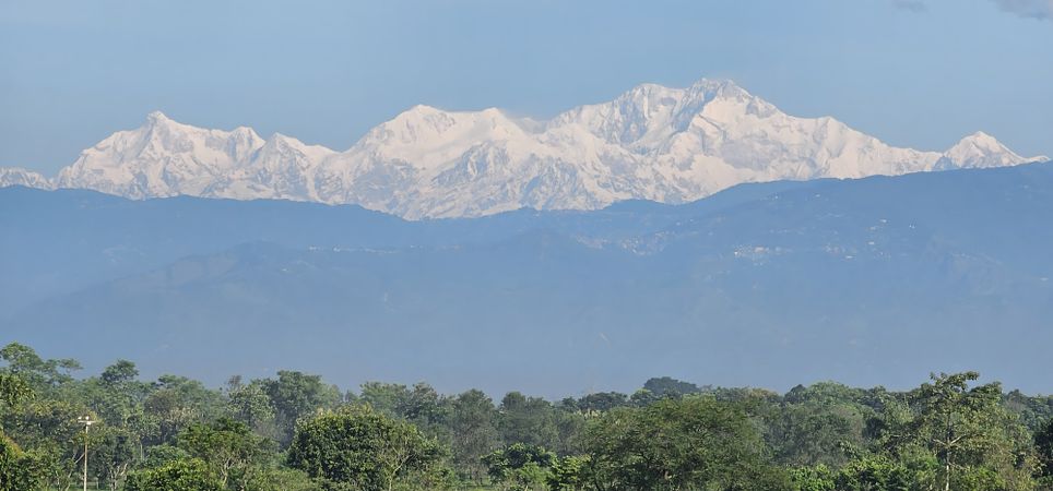 Majestic mountain range towering over green forest