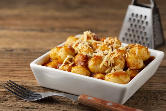 Gnocchi with tomato sauce and grated Parmesan cheese.