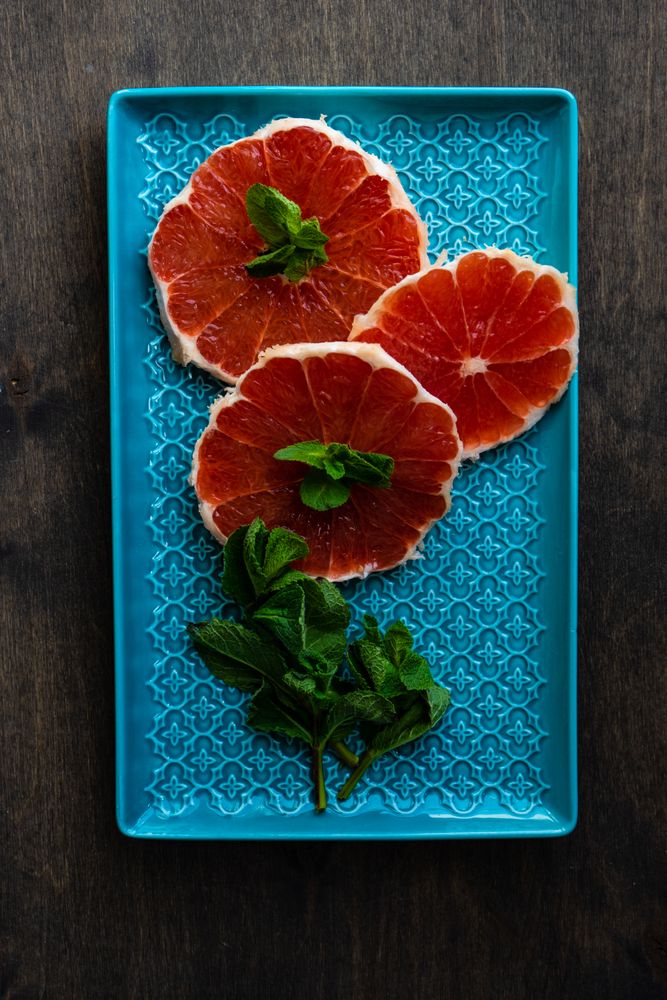 Freshly cut grapefruit slices with mint garnish