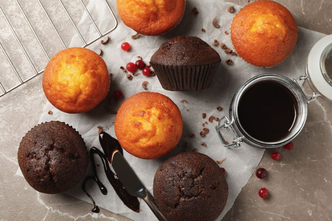 Composition with delicious muffins, berries, chocolate and baking paper