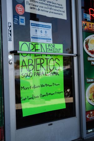 Sign in restaurant window offering take out only