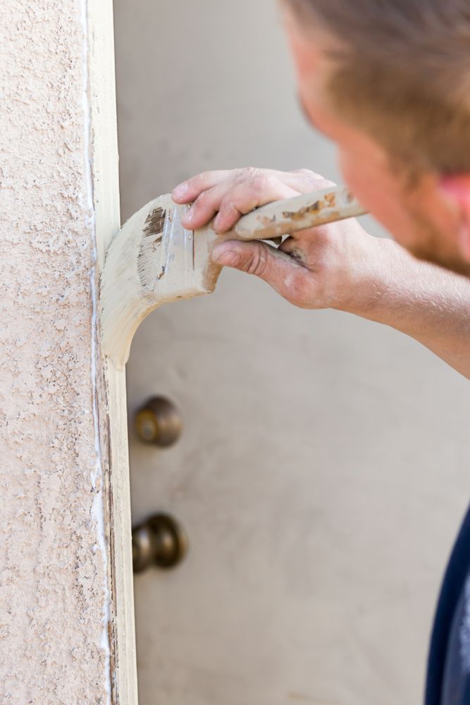 Professional Painter Cutting In With Brush to Paint House Door Frame.