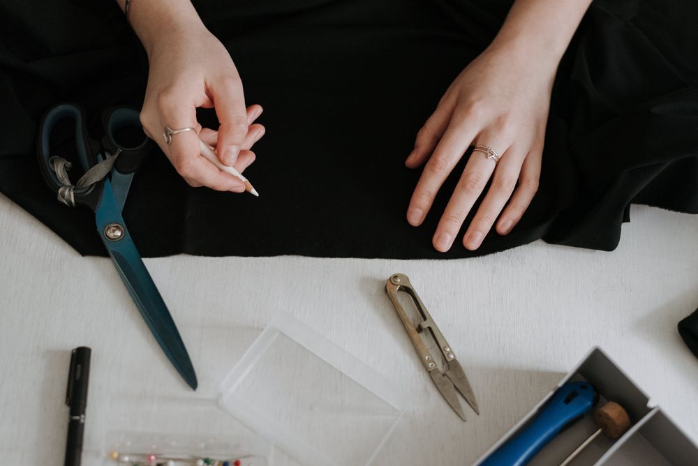 Cropped image of a tailor drawing guide marks on a garment