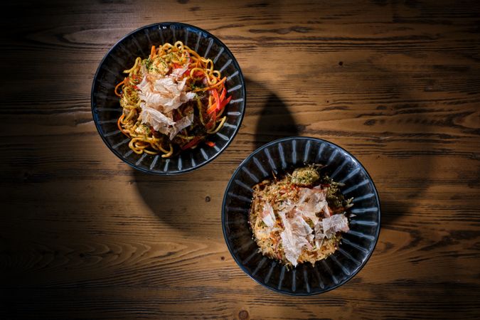 Delicious dishes in bowls served on wooden table