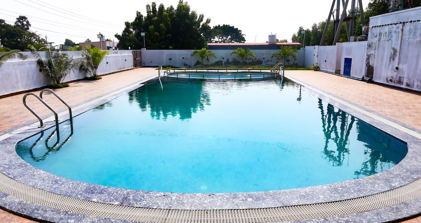Clean outdoor swimming pool with clear blue water at a resort