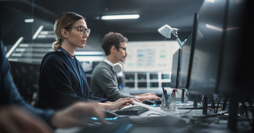 Portrait of a Thoughtful Young Engineer Working on Computer in a Technological Office Environment.