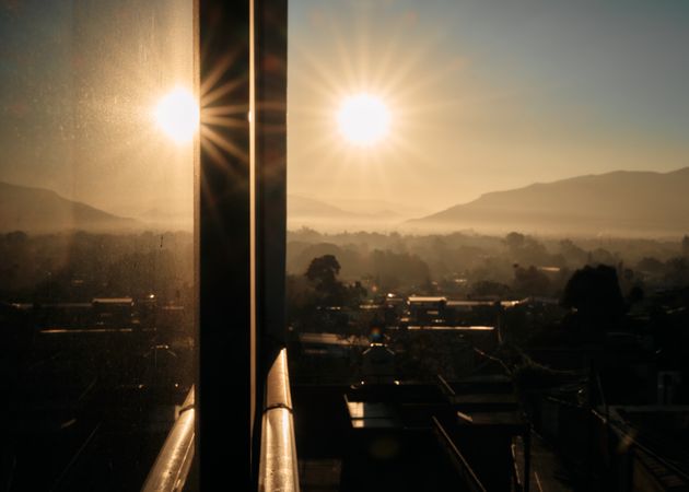 Looking out windows at beautiful view in Oaxaca with a reflection of the sun