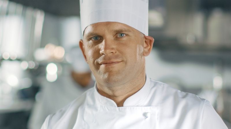 Close-up of a Famous Chef Smiling on Camera.