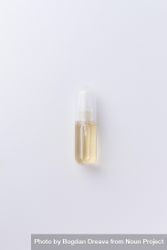Small perfume bottle over pale background 5pQ9y4