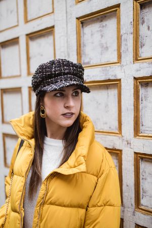 Stylish woman near shabby wall on street