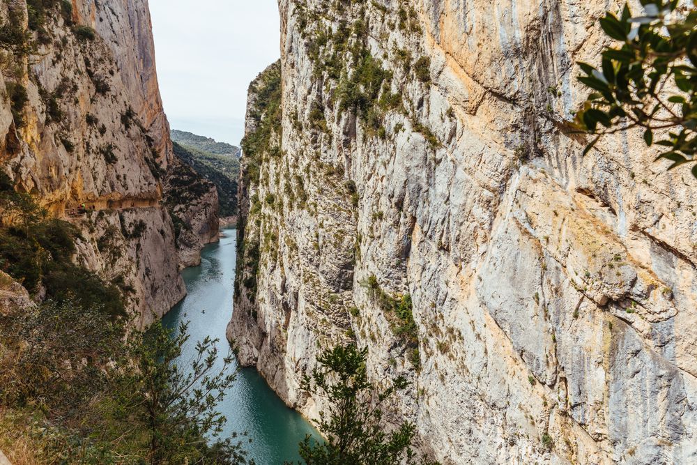 People crossing a river by kayak