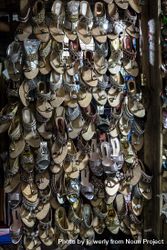 A wall of hung up shoes in a market 4ZMqW5