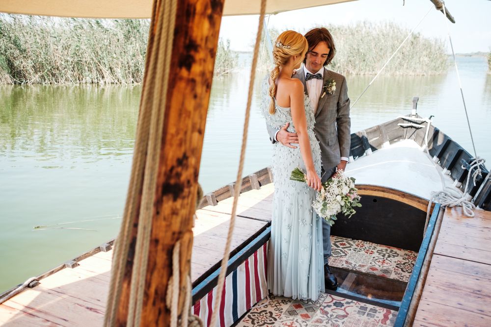 Couple holding hands while on boat