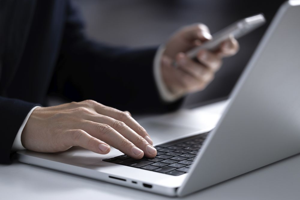 Businessman Balancing Laptop Work and Online Shopping