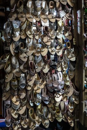 A wall of hung up shoes in a market