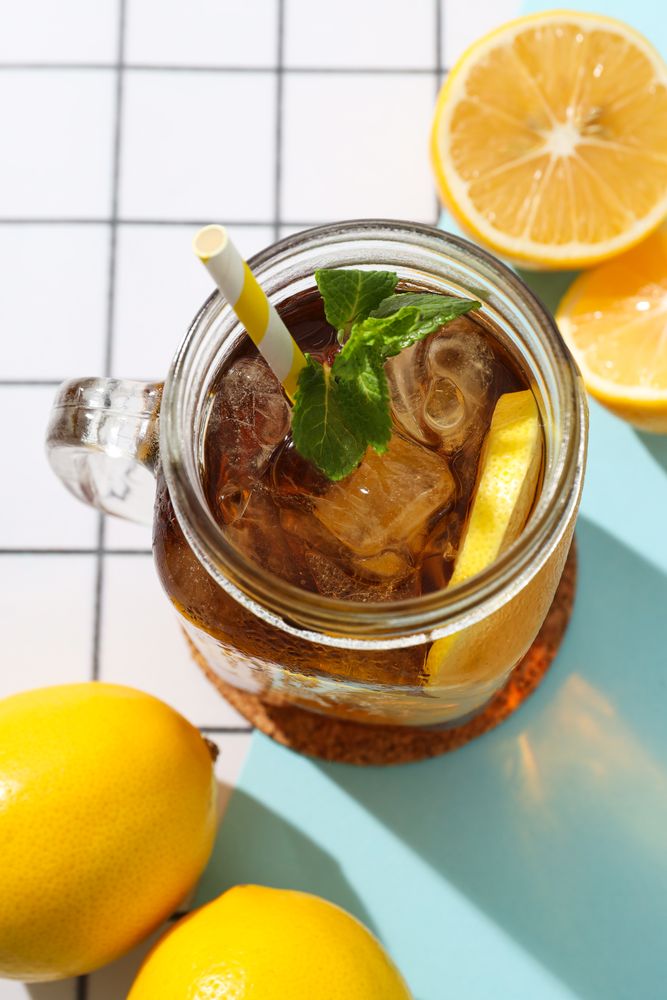 A glass of cold tea with fresh orange slices