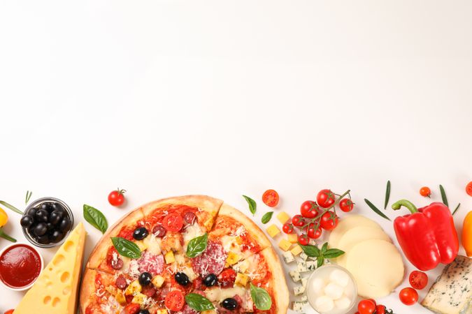 Flat lay. Pizza and ingredients: vegetables, cheese on plain background, copy space