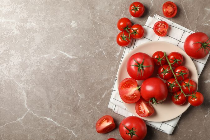 Composition with tomatoes on gray background, top view