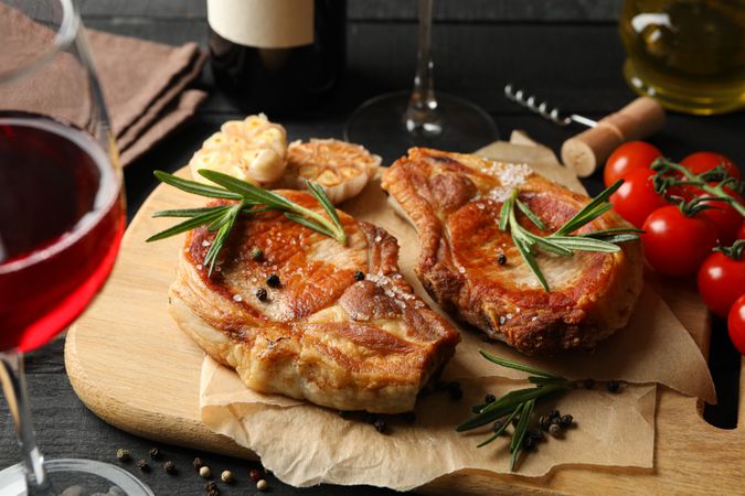 Composition with fried steaks and wine. Grilled food