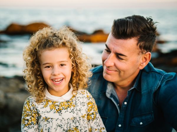Father with her daughter at beach