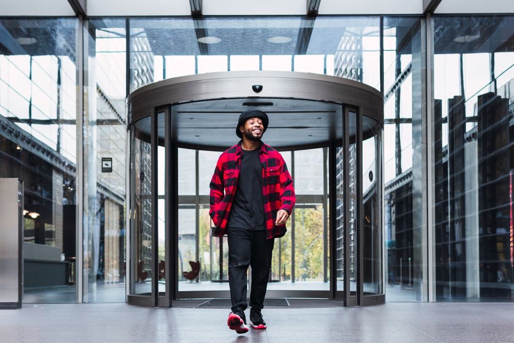 Man near glass building entrance