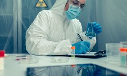 Scientist with protection suit investigating in the laboratory